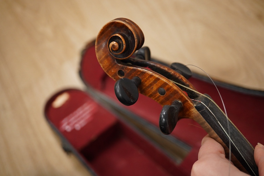 Two cased violins; one French 19th century bearing a hand written label for Francesco Werentle 1746, body length 35.5cm, the other an early 20th century violin, body length 35cm. Condition - poor.